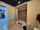 Neutral toned bathroom with tub, tile surround, toilet, and view into the kitchen at 4750 N Central Ave # R3, Phoenix, AZ 85012