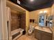 Bright bathroom featuring a toilet, sink, vanity, mirror, and shower-tub with tiled walls at 4750 N Central Ave # R3, Phoenix, AZ 85012
