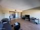 Bright living room featuring wood-look floors, and an open floor plan to a kitchen at 4750 N Central Ave # R3, Phoenix, AZ 85012