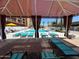 A refreshing pool view from beneath a shaded cabana with several lounge chairs ready for relaxing at 4750 N Central Ave # R3, Phoenix, AZ 85012