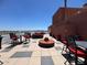 Spacious rooftop deck featuring ample seating, tables, and stunning city views on a sunny day at 4750 N Central Ave # R3, Phoenix, AZ 85012