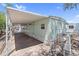 Exterior side view with covered parking, gravel landscaping, and utility access at 535 S Alma School Rd # 17, Mesa, AZ 85210