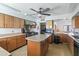 Spacious kitchen featuring wooden cabinets, stainless steel appliances, a center island, and ample counter space at 535 S Alma School Rd # 17, Mesa, AZ 85210