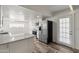 Modern kitchen featuring a breakfast bar, stainless steel appliances, and hardwood floors at 535 S Alma School Rd # 17, Mesa, AZ 85210