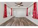 Open living room with hardwood floors, bright windows, and modern ceiling fan at 535 S Alma School Rd # 17, Mesa, AZ 85210