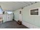 Covered patio includes storage shed, gravel flooring, and steps to door entry at 535 S Alma School Rd # 17, Mesa, AZ 85210
