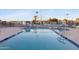 Relaxing community pool area with plenty of chairs and seating, secured fencing, and lush landscaping at 535 S Alma School Rd # 17, Mesa, AZ 85210