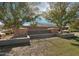 Stone monument sign for Magic Ranch neighborhood with desert landscaping and mature trees at 5781 E Iris Dr, Florence, AZ 85132