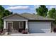 Charming single-story home with stone accents and a two-car garage, offering a cozy and inviting curb appeal at 5781 E Iris Dr, Florence, AZ 85132