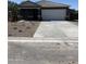 Inviting single-story home featuring a spacious driveway and meticulously xeriscaped front yard, ideal for low-maintenance living at 5781 E Iris Dr, Florence, AZ 85132