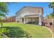 Expansive backyard with lush green lawn, covered patio, and mature landscaping at 6027 N 132Nd Dr, Litchfield Park, AZ 85340