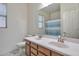 Bright bathroom featuring a double vanity, a large mirror, and a toilet at 6027 N 132Nd Dr, Litchfield Park, AZ 85340