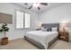 Inviting bedroom with neutral tones, a comfortable bed, and natural light from the window at 6027 N 132Nd Dr, Litchfield Park, AZ 85340
