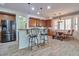 Charming kitchen with stainless steel appliances, light wood cabinets, and eat-in dining area at 6027 N 132Nd Dr, Litchfield Park, AZ 85340