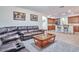Inviting living room with leather furniture and view of the kitchen, perfect for entertaining at 6027 N 132Nd Dr, Litchfield Park, AZ 85340