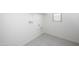 Utility room with tile floor, window, and white walls at 6057 E Artemis Dr, Florence, AZ 85132