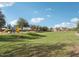 Community park featuring a green space, trees, and playground equipment, perfect for outdoor activities at 6064 E Artemis Dr, Florence, AZ 85132