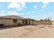 A home's backyard showcasing a covered patio, desert landscaping, and a brick privacy wall surrounding the property at 6103 S 54Th Ave, Laveen, AZ 85339