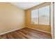 Bedroom with wood floors, neutral walls, white trim, and a window with blinds providing natural light at 6103 S 54Th Ave, Laveen, AZ 85339