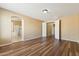 Large bedroom with wood floors and a view to the connected bathroom at 6103 S 54Th Ave, Laveen, AZ 85339