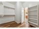 Walk-in closet with shelving, closet rods and access to the bathroom at 6103 S 54Th Ave, Laveen, AZ 85339