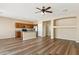 Spacious open-concept living room featuring wood floors and view of the kitchen at 6103 S 54Th Ave, Laveen, AZ 85339