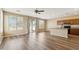Bright living room featuring wood floors, fan, natural light, and access to the backyard at 6103 S 54Th Ave, Laveen, AZ 85339