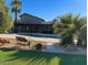This backyard features a gorgeous pool surrounded by patio, lush green grass, and mature palm trees at 6408 E Gary Rd, Scottsdale, AZ 85254
