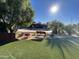 Expansive backyard featuring a pool, patio area, and manicured landscaping, creating a private oasis at 6408 E Gary Rd, Scottsdale, AZ 85254