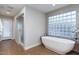 Bright bathroom featuring a modern soaking tub and separate glass-enclosed shower, creating a spa-like experience at 6408 E Gary Rd, Scottsdale, AZ 85254