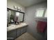 Bathroom featuring dual sinks, a large mirror, and neutral tones, creating a bright and functional space at 6408 E Gary Rd, Scottsdale, AZ 85254