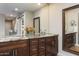 Bathroom with double sinks, granite countertops, and custom cabinets, providing a luxurious feel at 6408 E Gary Rd, Scottsdale, AZ 85254