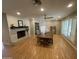 Open dining area with seating for six, lovely light fixture, fireplace and decorative shutters at 6408 E Gary Rd, Scottsdale, AZ 85254