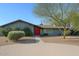 Charming single-story home featuring a red front door, desert landscaping, and a paved walkway at 6408 E Gary Rd, Scottsdale, AZ 85254