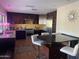 Modern kitchen with stainless steel appliances, dark cabinets, and a breakfast bar at 6408 E Gary Rd, Scottsdale, AZ 85254