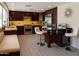 Gourmet kitchen with stainless steel appliances, a breakfast bar, and a cozy built-in bench seating at 6408 E Gary Rd, Scottsdale, AZ 85254