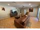 Bright living room features stylish leather seating, light wood floors, and natural light at 6408 E Gary Rd, Scottsdale, AZ 85254