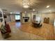 Open living room with a fireplace and wood floors and a chandelier at 6408 E Gary Rd, Scottsdale, AZ 85254