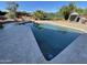Backyard swimming pool with stone tile surround and lush landscaping at 6408 E Gary Rd, Scottsdale, AZ 85254