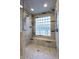 Luxurious shower with dual shower heads, a built-in bench, and elegant tile work, providing a spa-like experience at 6408 E Gary Rd, Scottsdale, AZ 85254