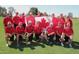 Enthusiastic group photo of people on a golf course, with a Canadian flag and cheerful community spirit at 6873 S Lake Forest Ct, Chandler, AZ 85249