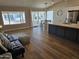 Open-concept living and kitchen area with wood floors and large windows offering natural light at 6873 S Lake Forest Ct, Chandler, AZ 85249