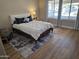 Comfortable bedroom featuring a modern bed, plush rug, and large window offering ample natural light at 6873 S Lake Forest Ct, Chandler, AZ 85249