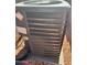 Close-up of the home's air conditioner unit with a maintenance sticker at 7046 N 84Th Dr, Glendale, AZ 85305