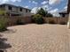 Backyard with a paved patio, desert landscaping, and block wall at 7046 N 84Th Dr, Glendale, AZ 85305