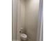 Toilet in half-bathroom featuring tile floors and white walls at 7046 N 84Th Dr, Glendale, AZ 85305