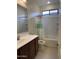 Bright bathroom featuring a shower-tub combo with decorative shower curtain and a vanity with a white countertop at 7046 N 84Th Dr, Glendale, AZ 85305