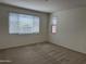 Cozy bedroom features two large windows providing lots of natural light over neutral carpet at 7046 N 84Th Dr, Glendale, AZ 85305