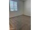 A carpeted bedroom featuring a window with blinds and neutral paint at 7046 N 84Th Dr, Glendale, AZ 85305