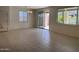 Open dining room featuring tile floors, large windows, and access to backyard through sliding doors at 7046 N 84Th Dr, Glendale, AZ 85305